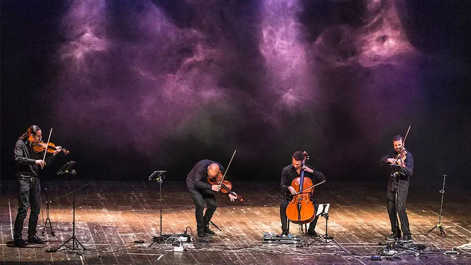 Ondanueve String Quartet performing live on a theatre stage